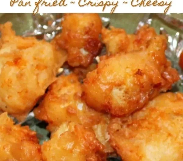 Cheddar fried cauliflower bites on a plate, golden and crispy.