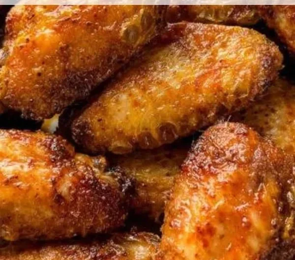 Delicious dry rub chicken wings served with dipping sauce on a platter.