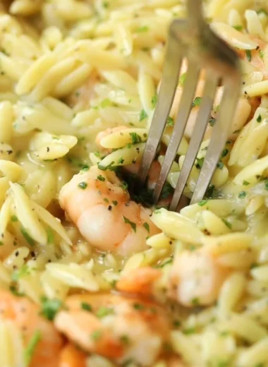 Delicious Garlic Butter Prawn Orzo garnished with herbs on a plate