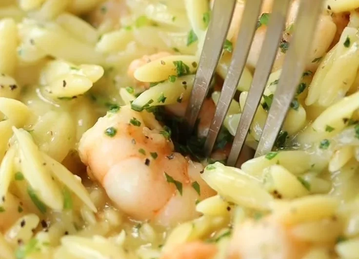 Delicious Garlic Butter Prawn Orzo garnished with herbs on a plate