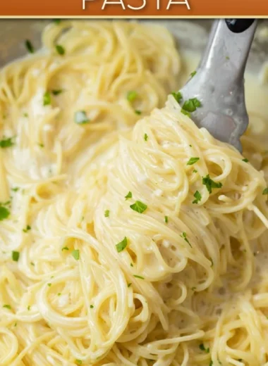 Bowl of creamy garlic parmesan pasta garnished with parsley and grated cheese