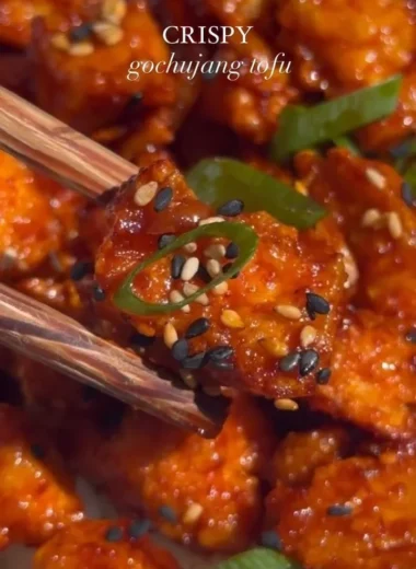 Delicious Gochujang Tofu served with vegetables and sesame seeds
