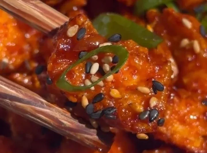 Delicious Gochujang Tofu served with vegetables and sesame seeds