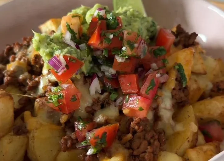 Delicious Loaded Potato Taco Bowl topped with fresh ingredients and sauces