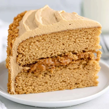 Delicious homemade Biscoff Cake topped with caramel and biscuit crumbs