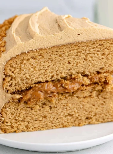 Delicious homemade Biscoff Cake topped with caramel and biscuit crumbs