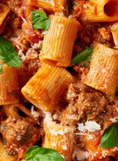Delicious classic Bolognese sauce simmering in a pot with fresh ingredients.
