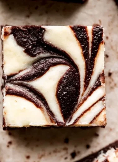 Delicious cheesecake marble brownies with swirls of cream cheese on top