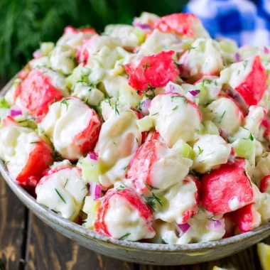 Delicious crab salad with fresh ingredients and dressing served in a bowl