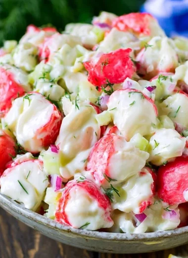 Delicious crab salad with fresh ingredients and dressing served in a bowl