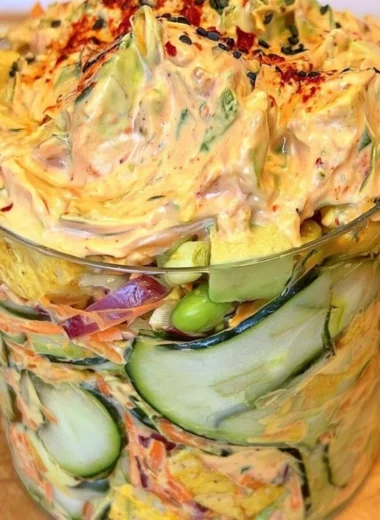 Creamy Asian cucumber salad with colorful vegetables and dressing