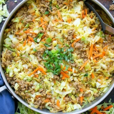 Delicious egg roll in a bowl with colorful vegetables and savory pork.