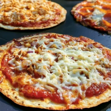 Delicious homemade Blackstone Griddle pizza cooking on a flat-top grill.