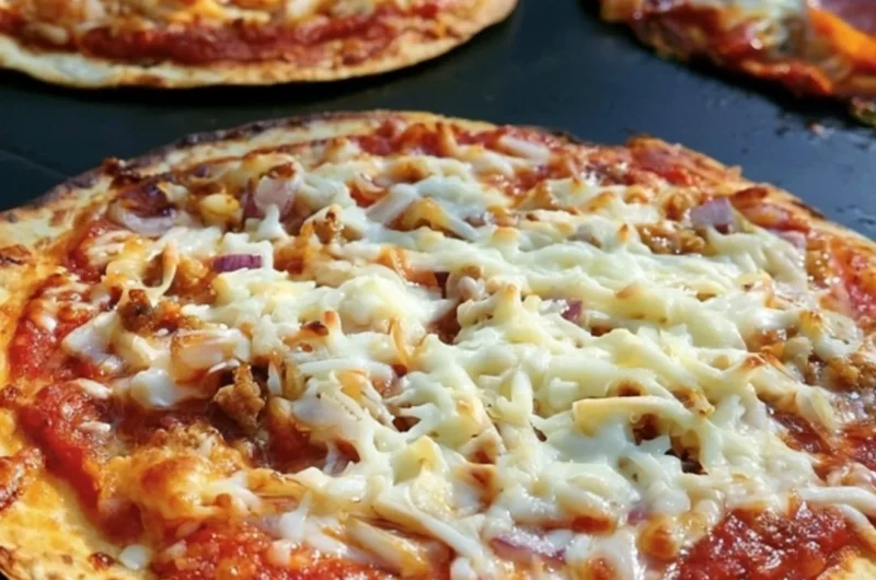 Delicious homemade Blackstone Griddle pizza cooking on a flat-top grill.