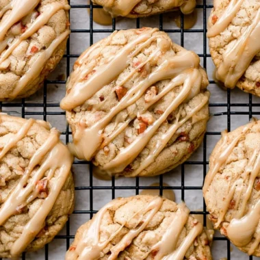 Freshly baked maple brown sugar cookies with a golden hue on a baking tray.