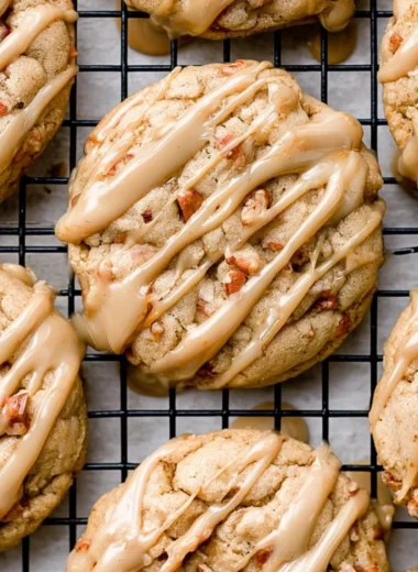 Freshly baked maple brown sugar cookies with a golden hue on a baking tray.