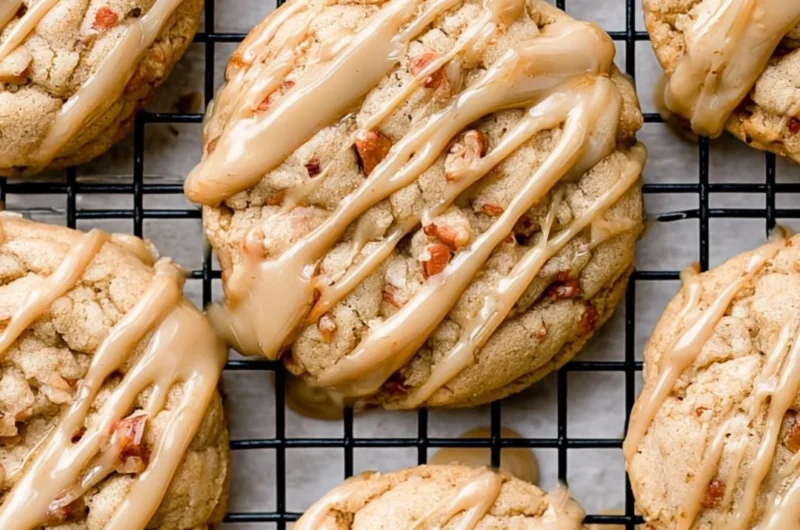 Freshly baked maple brown sugar cookies with a golden hue on a baking tray.