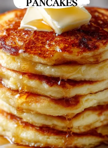 Plate of old-fashioned pancakes topped with syrup and berries