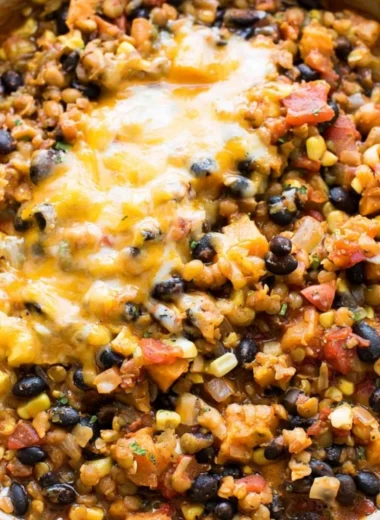 Delicious One Pot Mexican Lentils served in a bowl with colorful toppings.