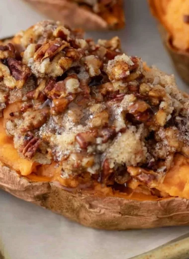 Pecan Pie Twice Baked Sweet Potatoes topped with pecans and caramel glaze