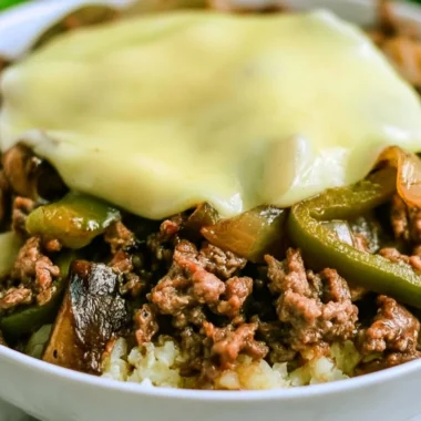 Delicious low-carb Philly Cheesesteak bowls topped with cheese and peppers.