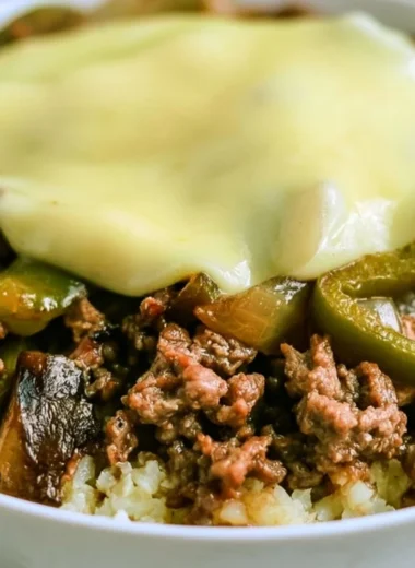 Delicious low-carb Philly Cheesesteak bowls topped with cheese and peppers.