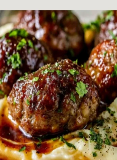Salisbury steak meatballs with garlic herb mashed potatoes on a plate