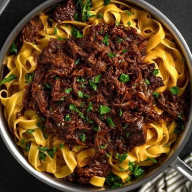 Delicious bowl of slow-cooked short rib ragù served over pasta.