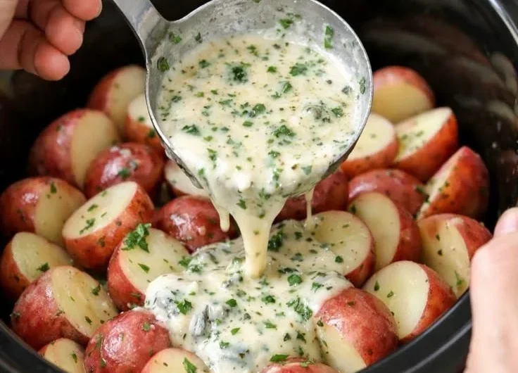 Delicious slow cooker herb ranch potatoes garnished with fresh herbs.