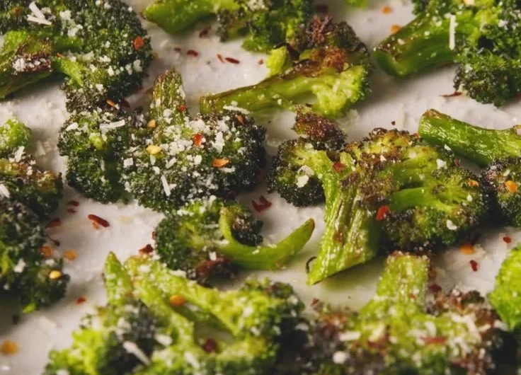 Plate of smashed broccoli with garlic and olive oil