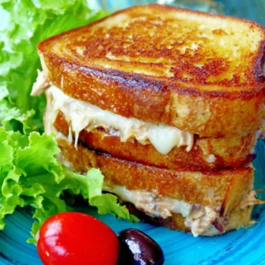 Delicious tuna melt sandwich with melted cheese and flaky tuna on toasted bread