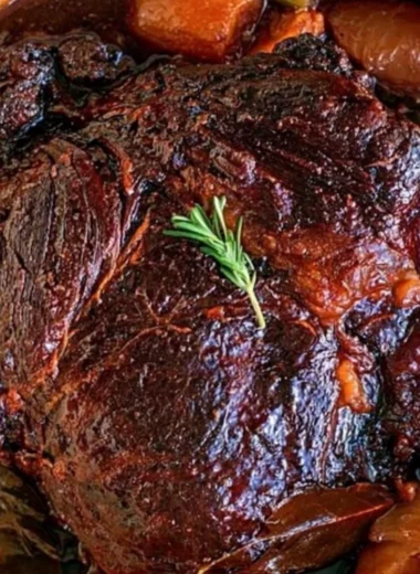 Delicious beef chuck roast cooked to perfection, served with vegetables.