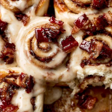 Cozy bourbon maple bacon cinnamon rolls topped with delicious syrup