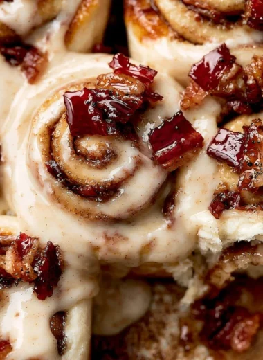 Cozy bourbon maple bacon cinnamon rolls topped with delicious syrup