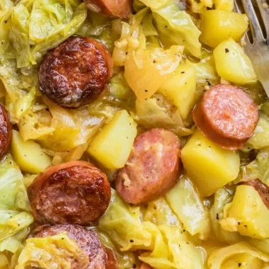 Warm dish of cabbage, potatoes, and sausage served in a bowl