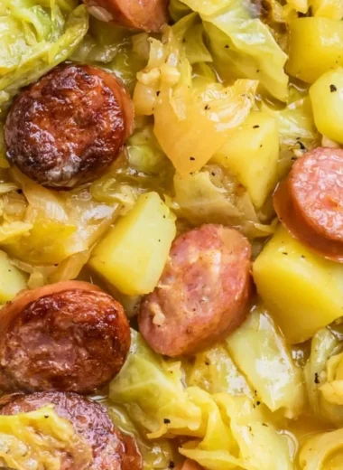Warm dish of cabbage, potatoes, and sausage served in a bowl