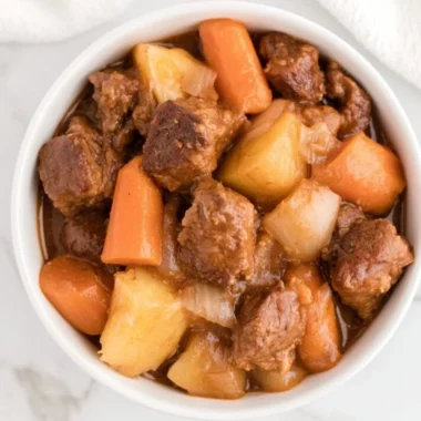 Cozy crockpot beef stew simmering with vegetables and beef.