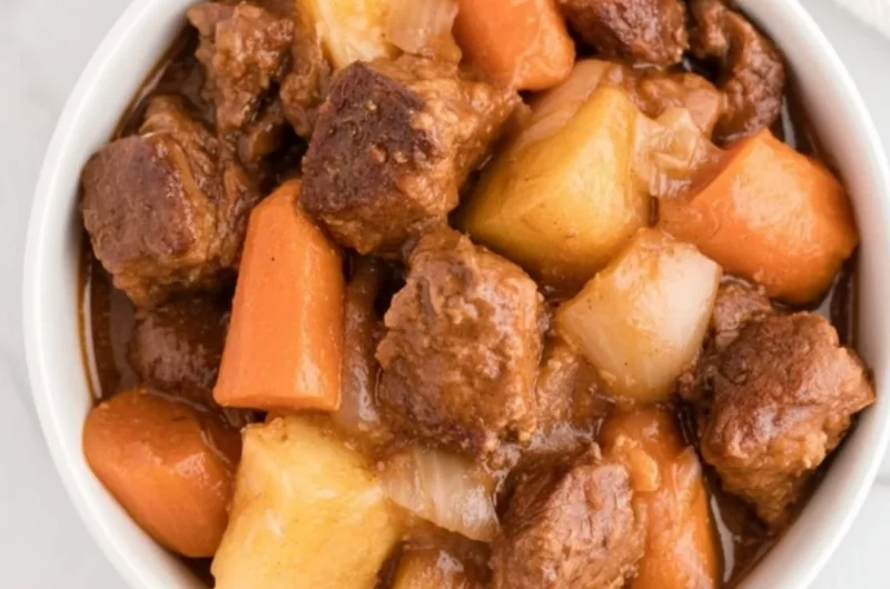 Cozy crockpot beef stew simmering with vegetables and beef.