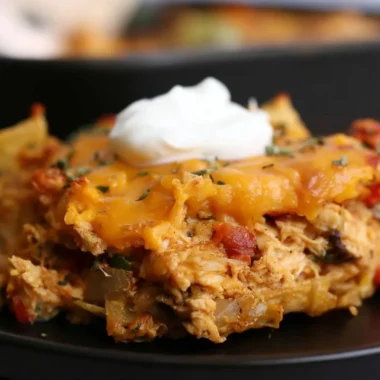 Delicious King Ranch Chicken Casserole topped with cheese and served in a baking dish.