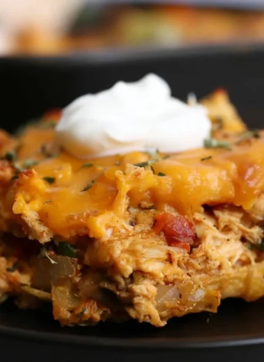 Delicious King Ranch Chicken Casserole topped with cheese and served in a baking dish.