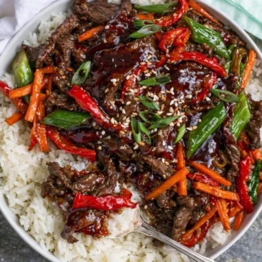 Delicious cozy Mongolian Beef served with green onions and rice