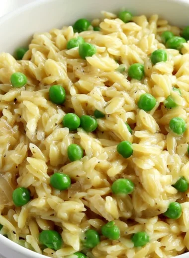 Delicious creamy orzo dish topped with fresh herbs and cheese.