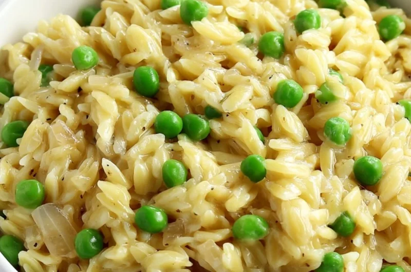 Delicious creamy orzo dish topped with fresh herbs and cheese.