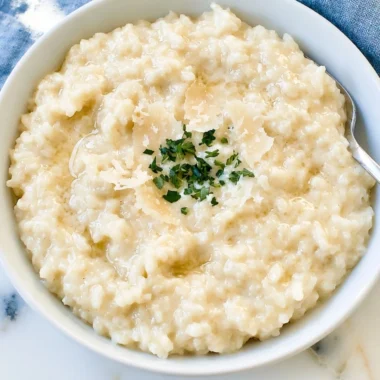 Creamy Parmesan Risotto served in a bowl, garnished with parsley.