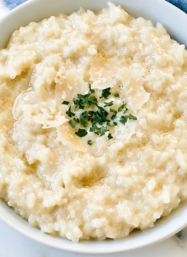 Creamy Parmesan Risotto served in a bowl, garnished with parsley.