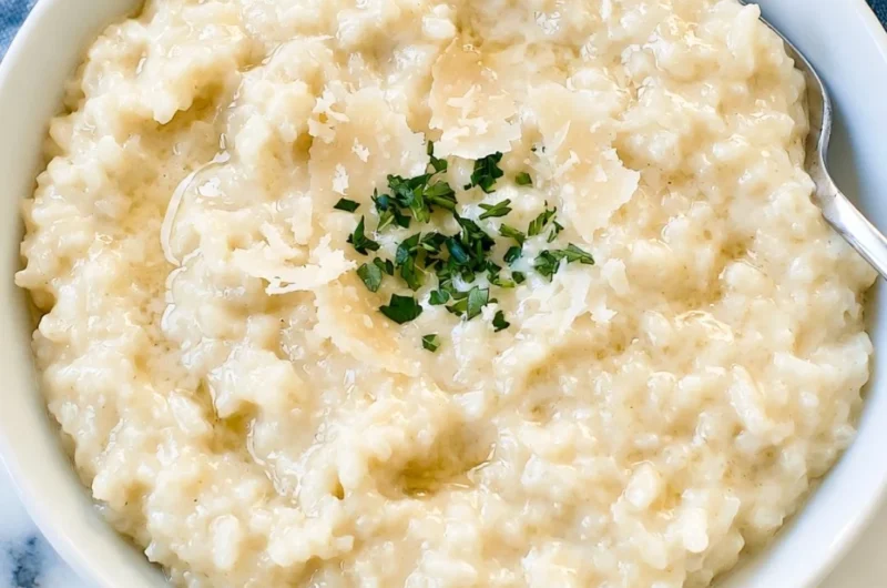 Creamy Parmesan Risotto served in a bowl, garnished with parsley.