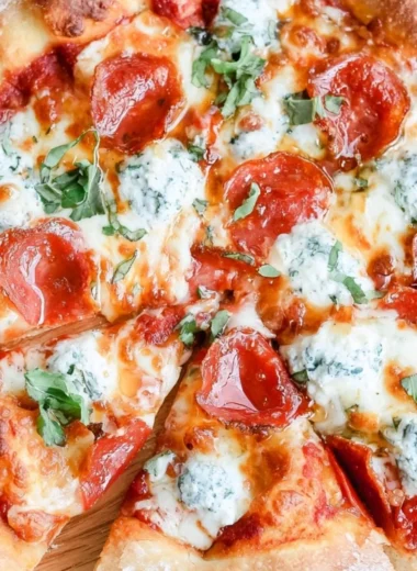Delicious hot honey pizza topped with cheese and spicy drizzle