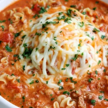 A delicious bowl of lasagna soup topped with cheese and herbs