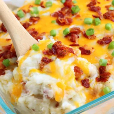 Loaded Baked Potato Casserole topped with cheese, bacon, and green onions