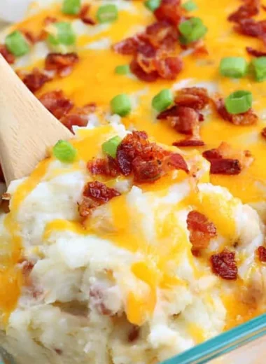 Loaded Baked Potato Casserole topped with cheese, bacon, and green onions